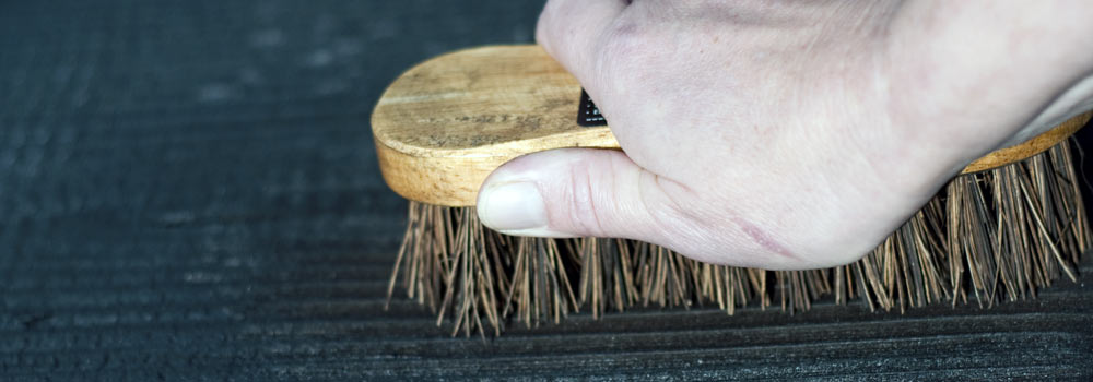 Brushing Yakisugi cedar by hand during finishing process by The Raised Bed Company