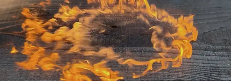 Yakisugi board being carbonised with controlled flame to create sustainable wooden raised beds