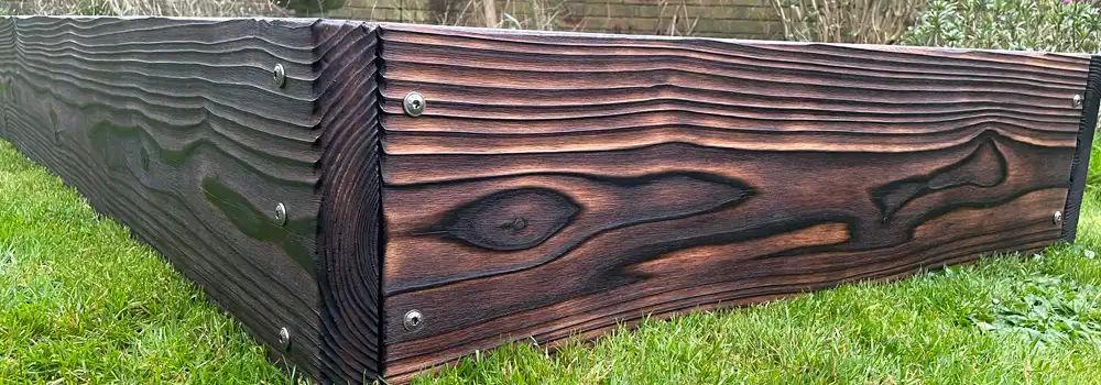 Thick timber raised bed showing how raised bed durability depends on board thickness, corner support and fixing layout