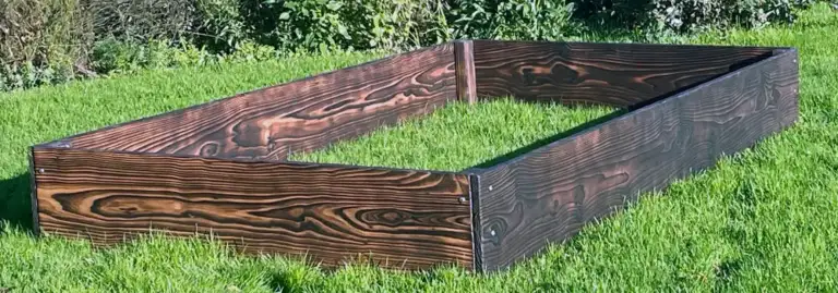 Raised bed vs planter comparison showing a true raised bed open to the ground