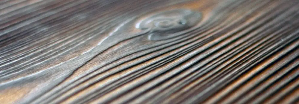 Close-up of Western Red Cedar with Yakisugi finish showing brushed grain and natural knot detail