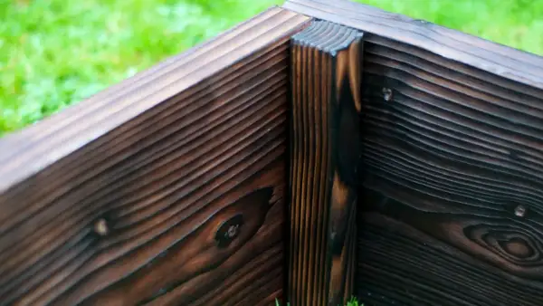 Western Red Cedar raised bed with Yakisugi finish showing internal corner post support and structural detailing